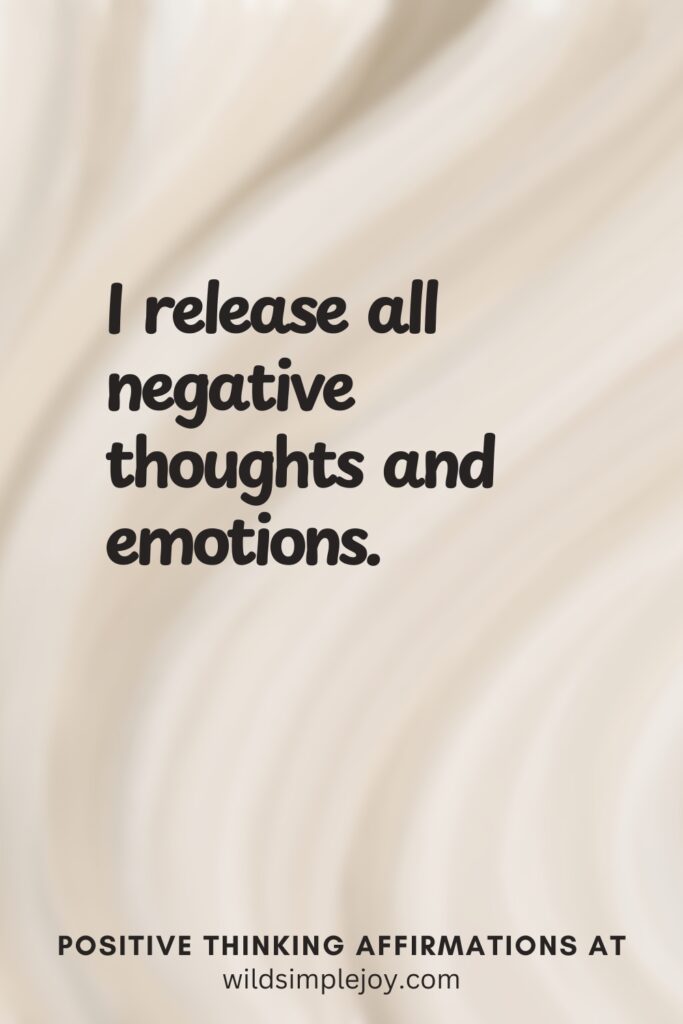 Vertical pin image on cream background with text overlay, I release all negative thoughts and emotions. Positive Thinking Affirmations at wildsimplejoy.com