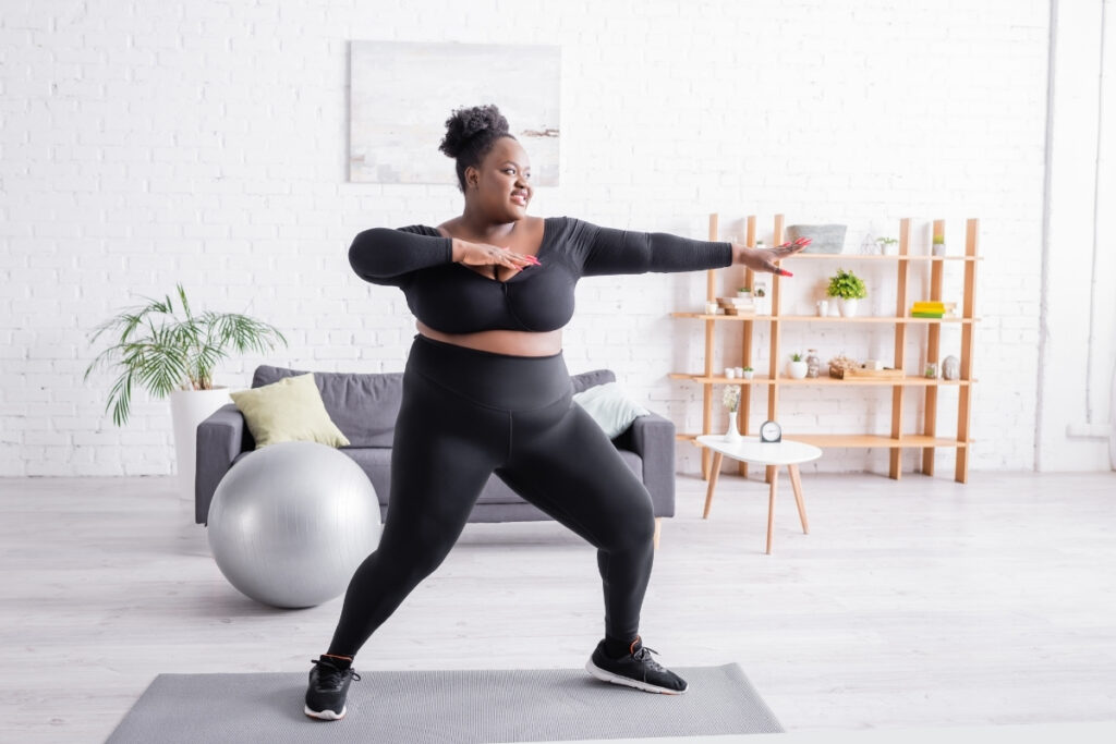 Beautiful woman exercising at home, asking herself What happens if you exercise without dieting?