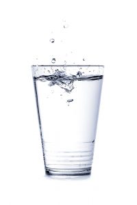 Glass of water--staying hydrated is a way to know how to clear blocked milk ducts.
