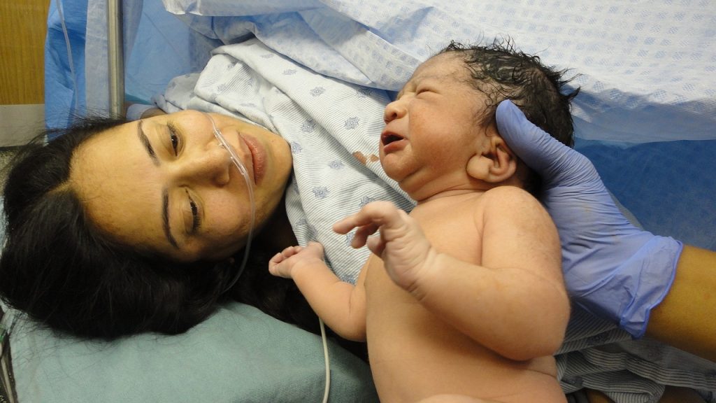 A woman and baby after c-section. How painful is giving birth via c-section?