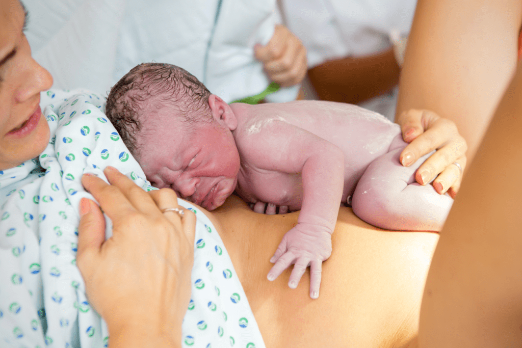 New mom and newborn baby after painful labor and childbirth