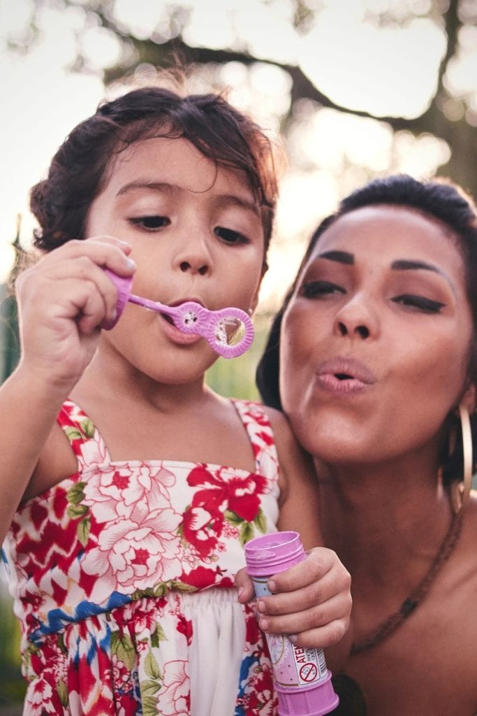 Mom with daughter learning how to balance work and kids.