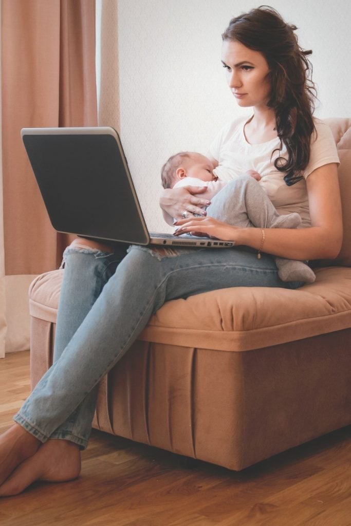 Mom breastfeeding and working on career multitasking - Working Mom Balancing Work and Family.