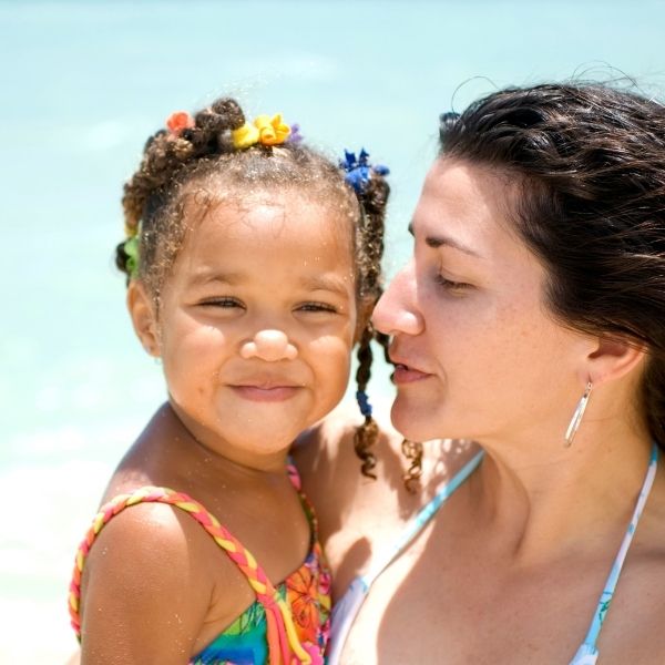 Mother being protective of her daughter at the beach