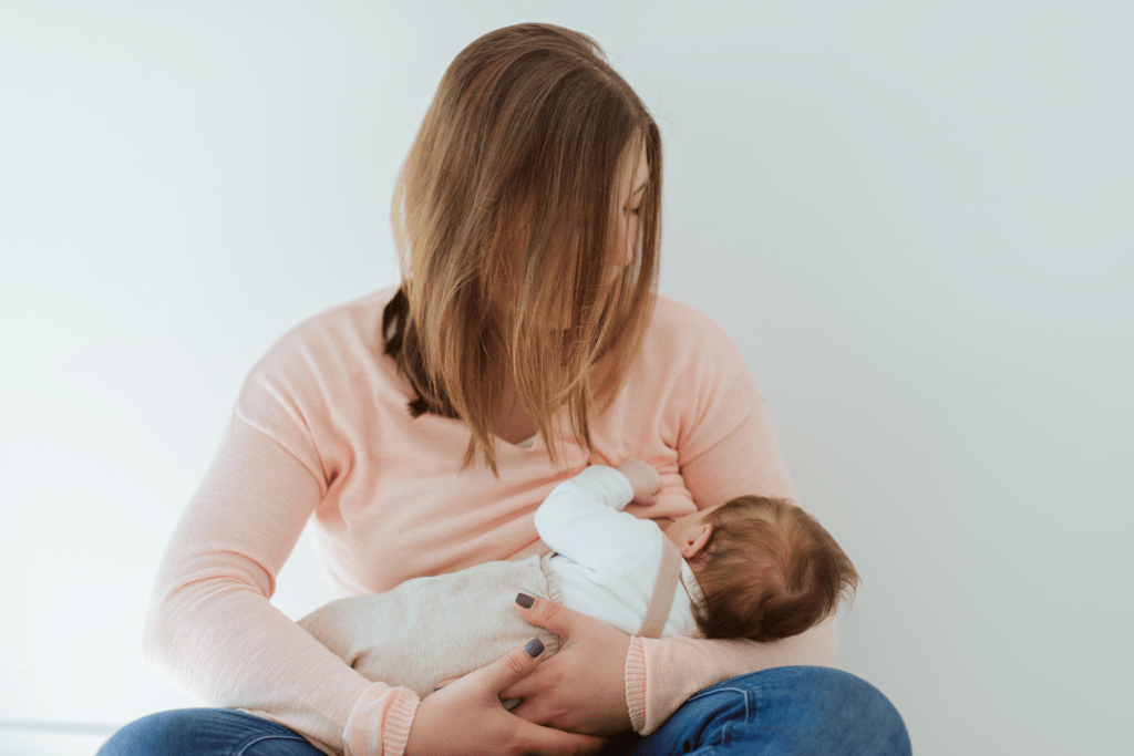 Mother nursing breastfeeding her newborn baby worries about not losing weight while breastfeeding.