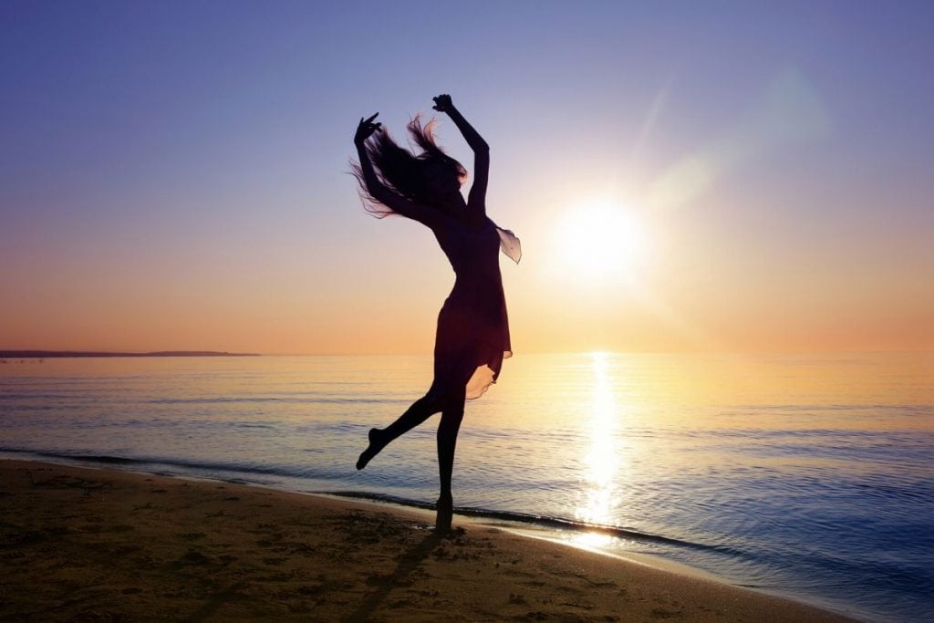 Woman dancing at sunset has a beautiful soul.