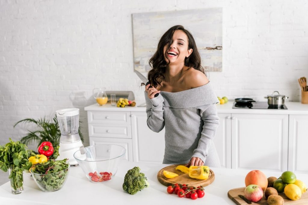 Woman in the kitchen preparing meal for Arbonne 30 Days to Healthy Living with Arbonne Products