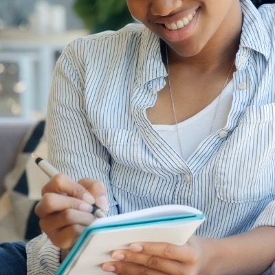 Woman writing down some evening routine ideas