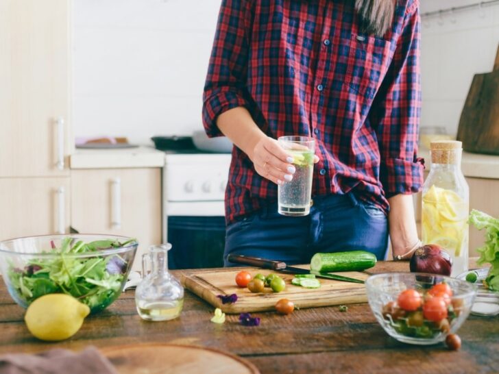 Woman making nutritious meal in the kitchen after reading the best books on nutrition.