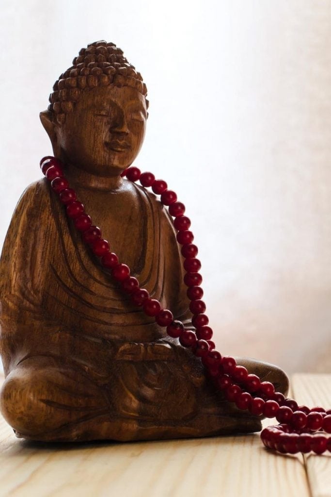 Buddha with mala- proper storage or display may impact how you choose the best mala beads for you