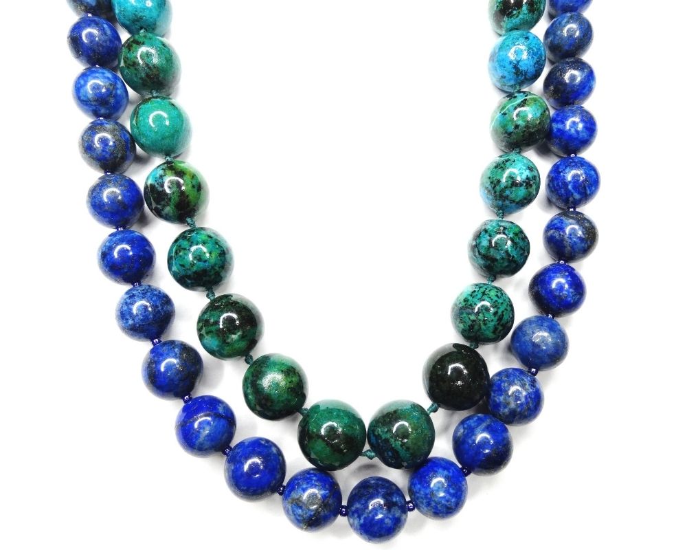 Green 8mm beads next to blue 6mm beads. The size of beads are helpful to consider when choosing the right mala beads.