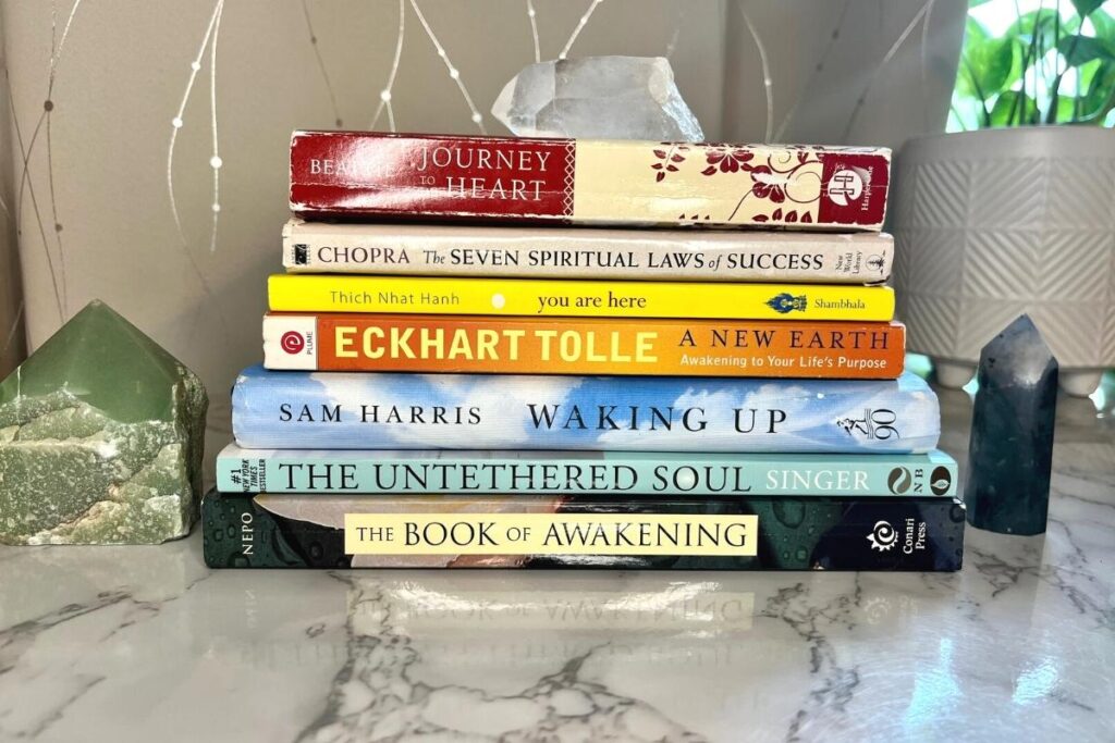 Seven of the best books on spiritual enlightenment, including Beattie Journey to the Heart, Chopra The Seven Spiritual Laws of Success, Thich Nhat Hanh You Are Here, Eckhardt Tolle A New Earth, Sam Harris Waking Up, Singer The Untethered Soul, Nepo The Book of Awakening