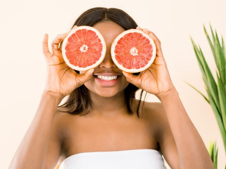 Woman with grapefruits enjoying the amazing benefits of self care