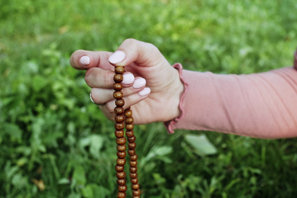 Woman chose a simple set of mala beads for meditation.