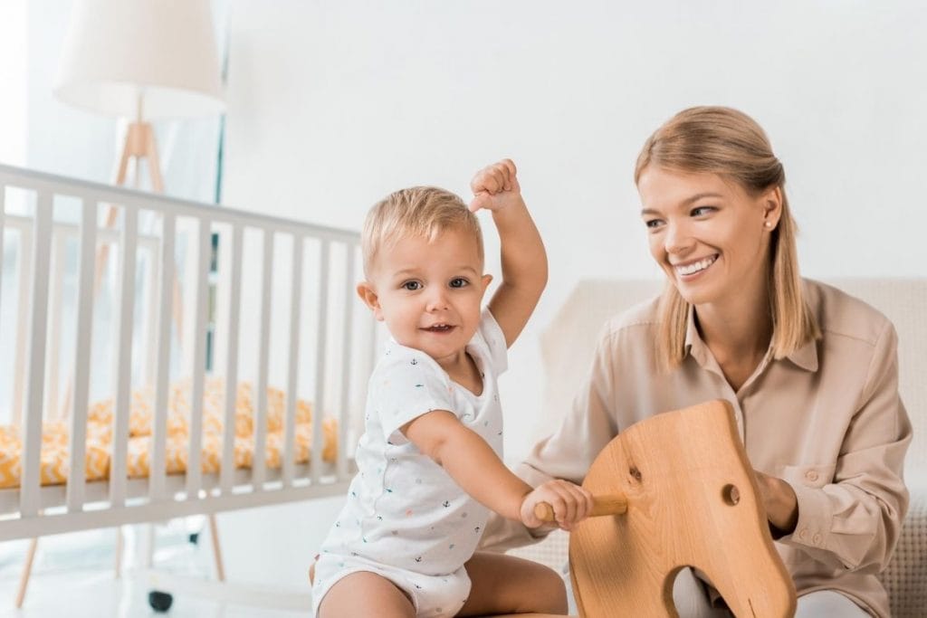 Child and mother playing with minimalist toddler toys.