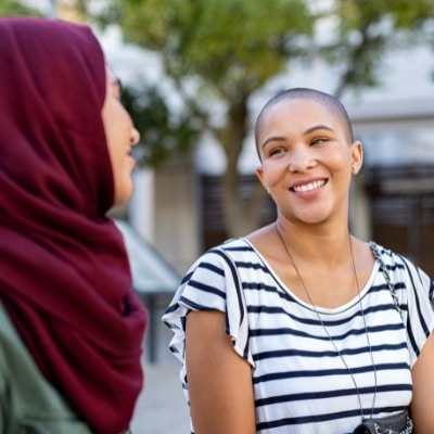 Two women spending time together and smiling. Spending time with the people we love can add to our happiness