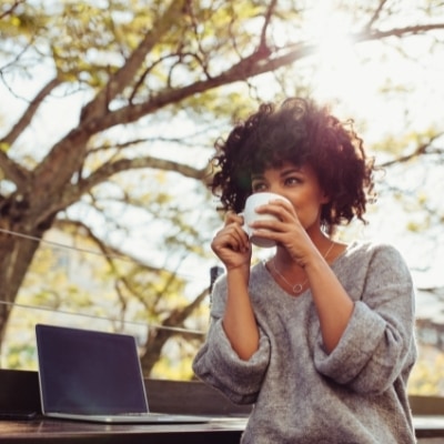 Woman drinking coffee, feeling joyful