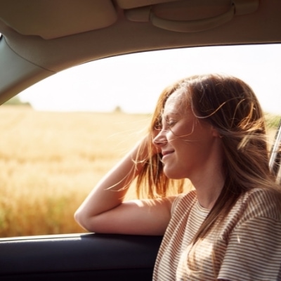 Woman enjoying the breeze and finding acceptance in the present moment