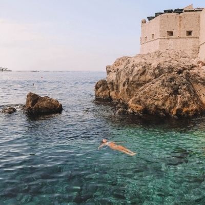 Woman finding surrender floating in a beautiful lake