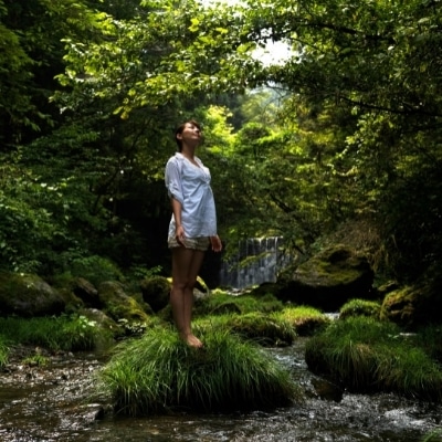 Woman standing in nature as a stress management technique