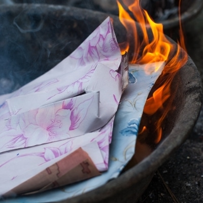 Papers burning. Writing down resentments and burning them are a way to symbolically let go of your pain