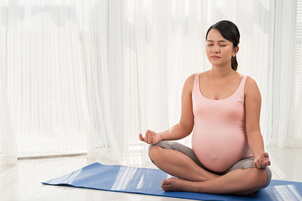 Pregnant woman using meditation and affirmations for a healthy pregnancy and birth