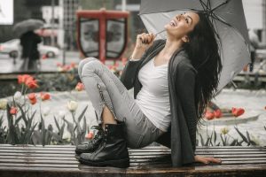Wild Woman letting herself feel free and joyful in the rain, practicing wild woman affirmations