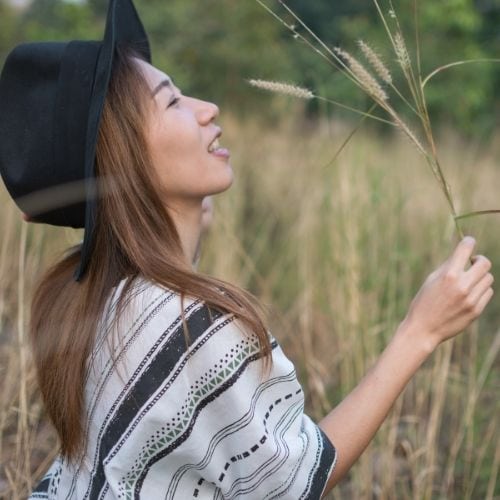 Woman daydreaming and looking at nature: Free Spirit Meaning.