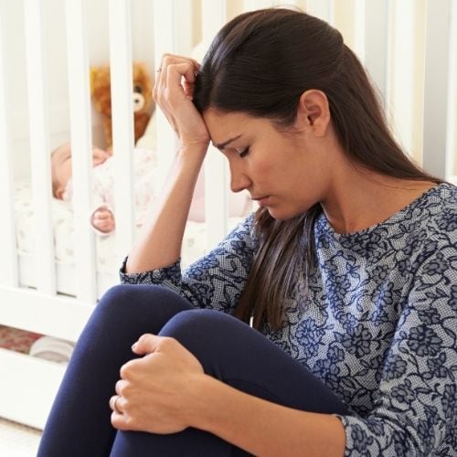 Woman feeling stressed. Stress can contribute to not losing weight while breastfeeding