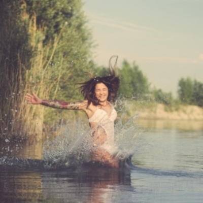 Woman listening to her instincts to enjoy herself and jump in the lake