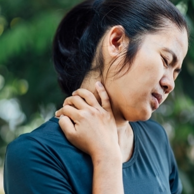 Woman noticing her neck tension and pain