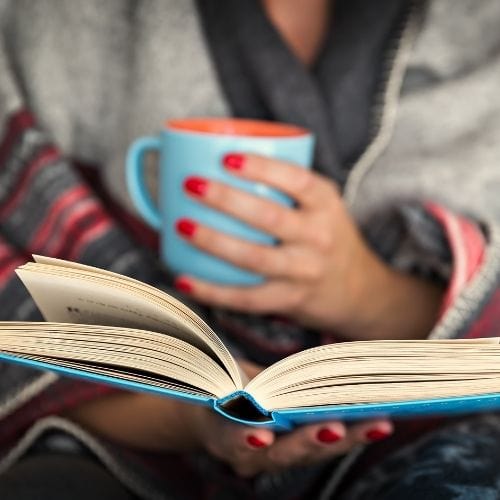 Woman reading books about how to become spiritually enlightened