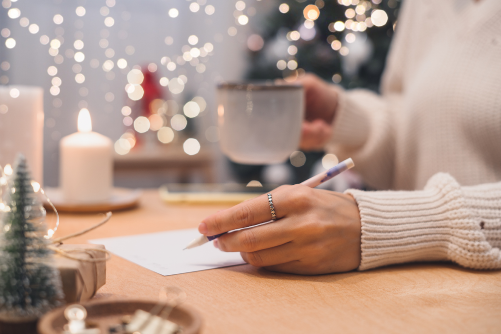 Woman writing down her New Year's resolution action plan in a calendar