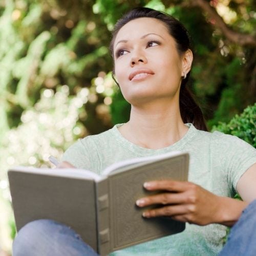 Woman writing down her emotions to learn to control them