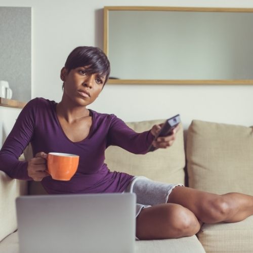 Your metabolism might slow down while you're breastfeeding, which might account for while you're not losing weight, Woman lounging on the couch