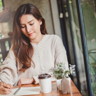 Woman writing affirmations