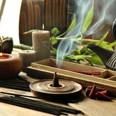 Spiritual altar with candles, tea, and incense.