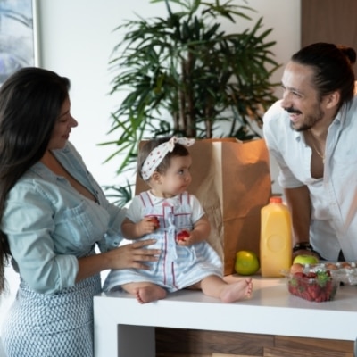 Mom, baby, and dad together in the kitchen