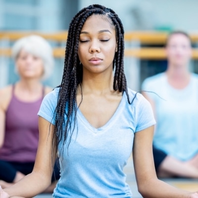 Woman meditating in yoga class