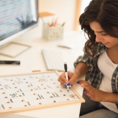 Woman writing in her calendar