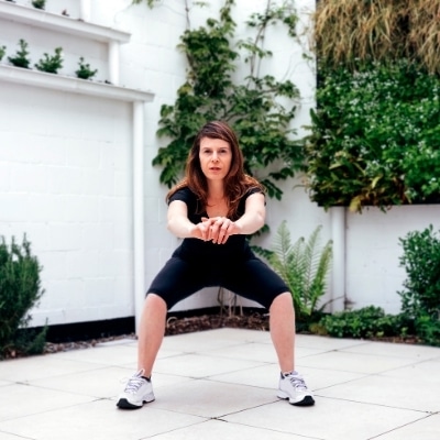 Woman exercising on her front driveway