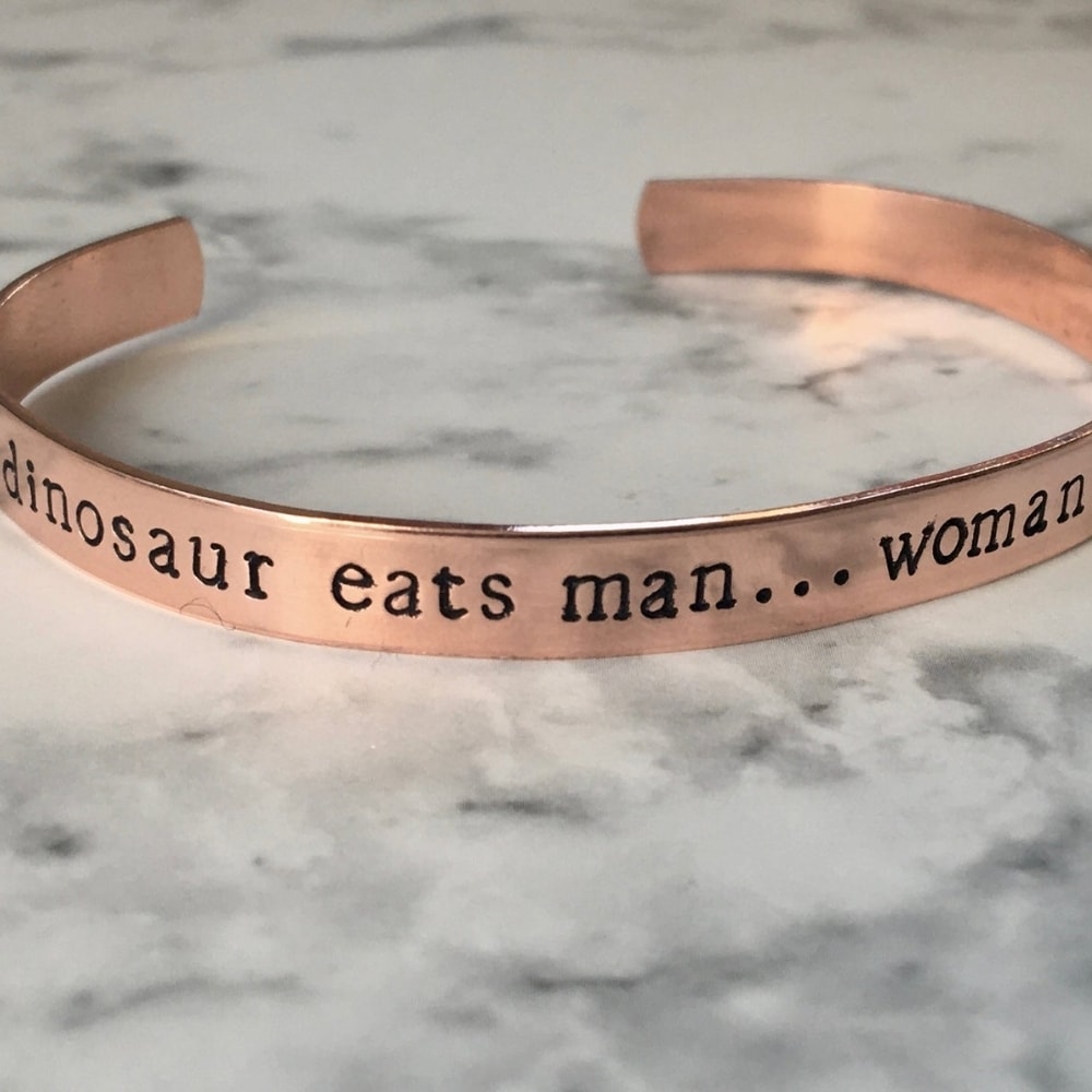 Dinosaur Eats Man, Woman Inherits the Earth Cuff Bracelet from Oak Lane Studio
