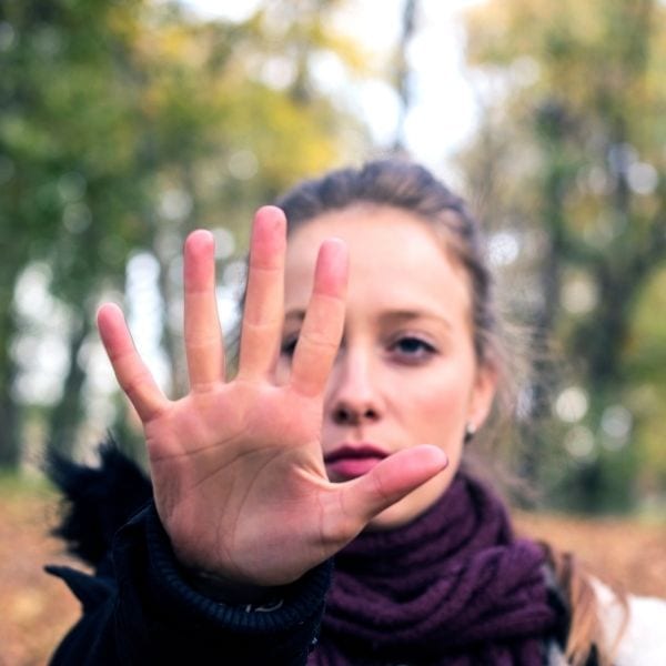 Woman saying no with "stop" hand.