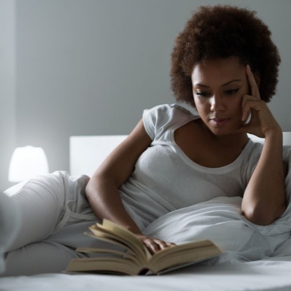 This woman is reading books about famous, strong women who set an example for personal empowerment for women