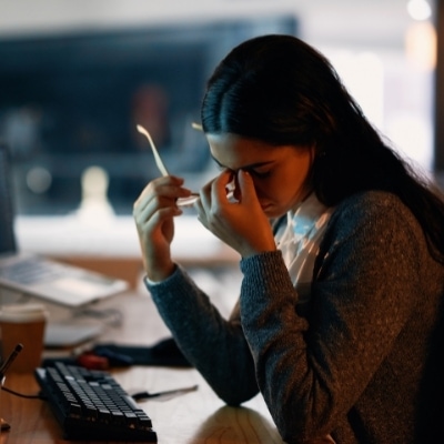 Woman holding her face in her hands because she feels like a failure