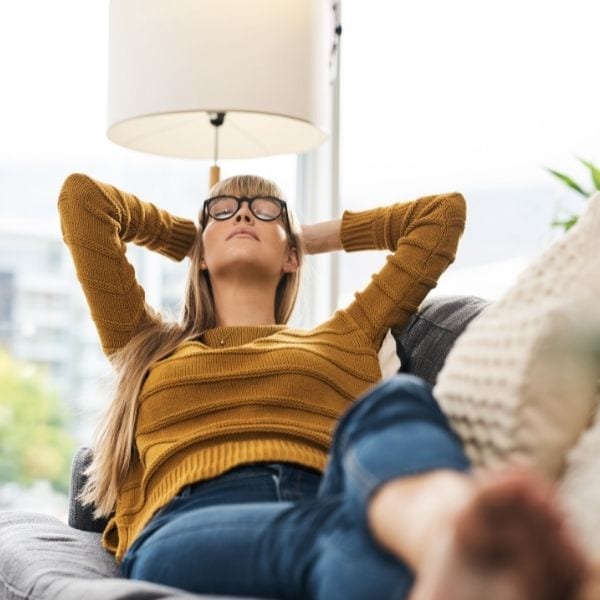 Woman relaxing and enjoying the benefits of self-care