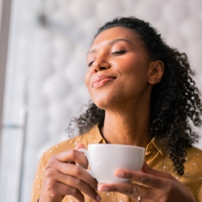 Woman enjoying tea and creating joy within herself