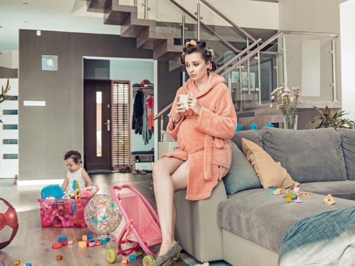 Young mother with baby and mess needs to put together a stay at home mom survival kit