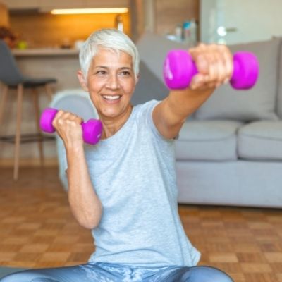 Elderly woman working out at home