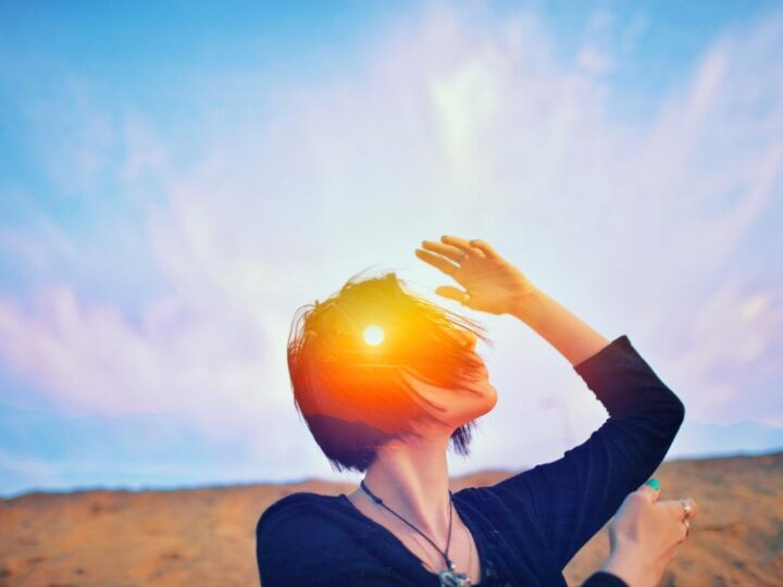 Woman standing in the sunset is developing personal sovereignty in a spiritual sense